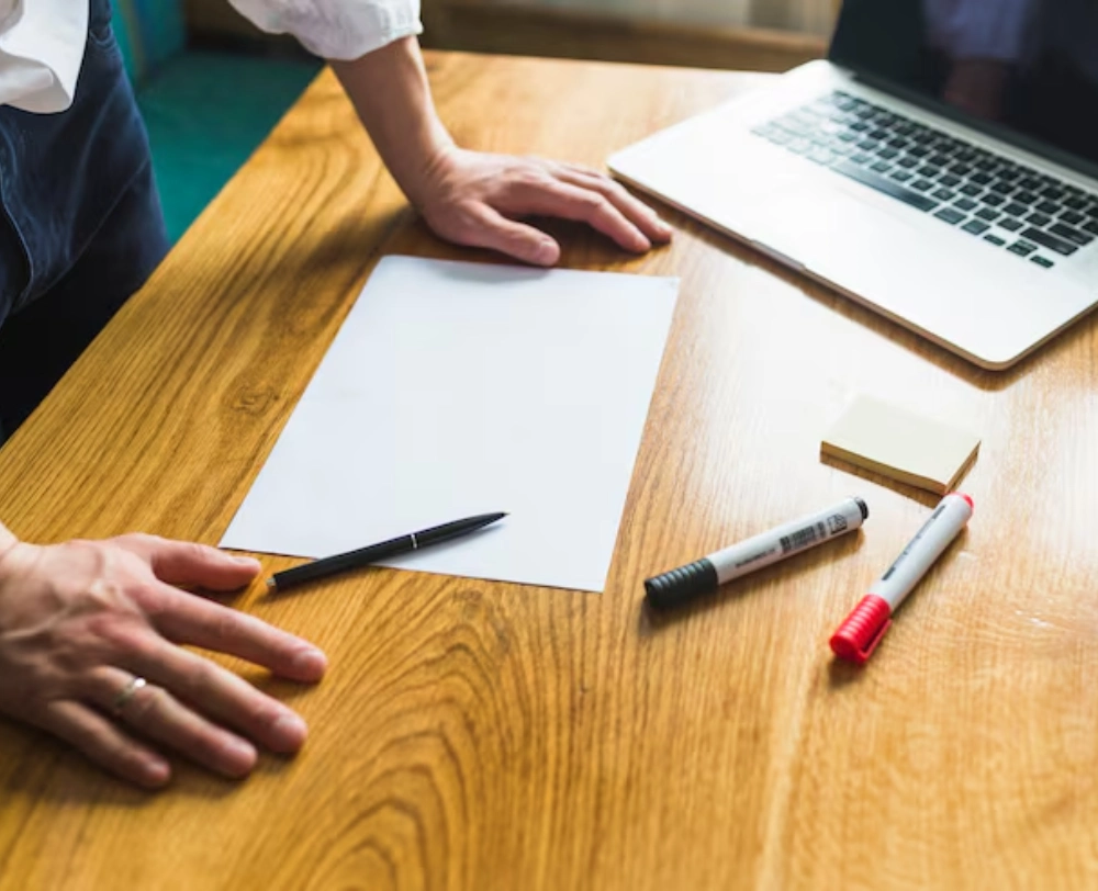 business person in front of a wooden desk